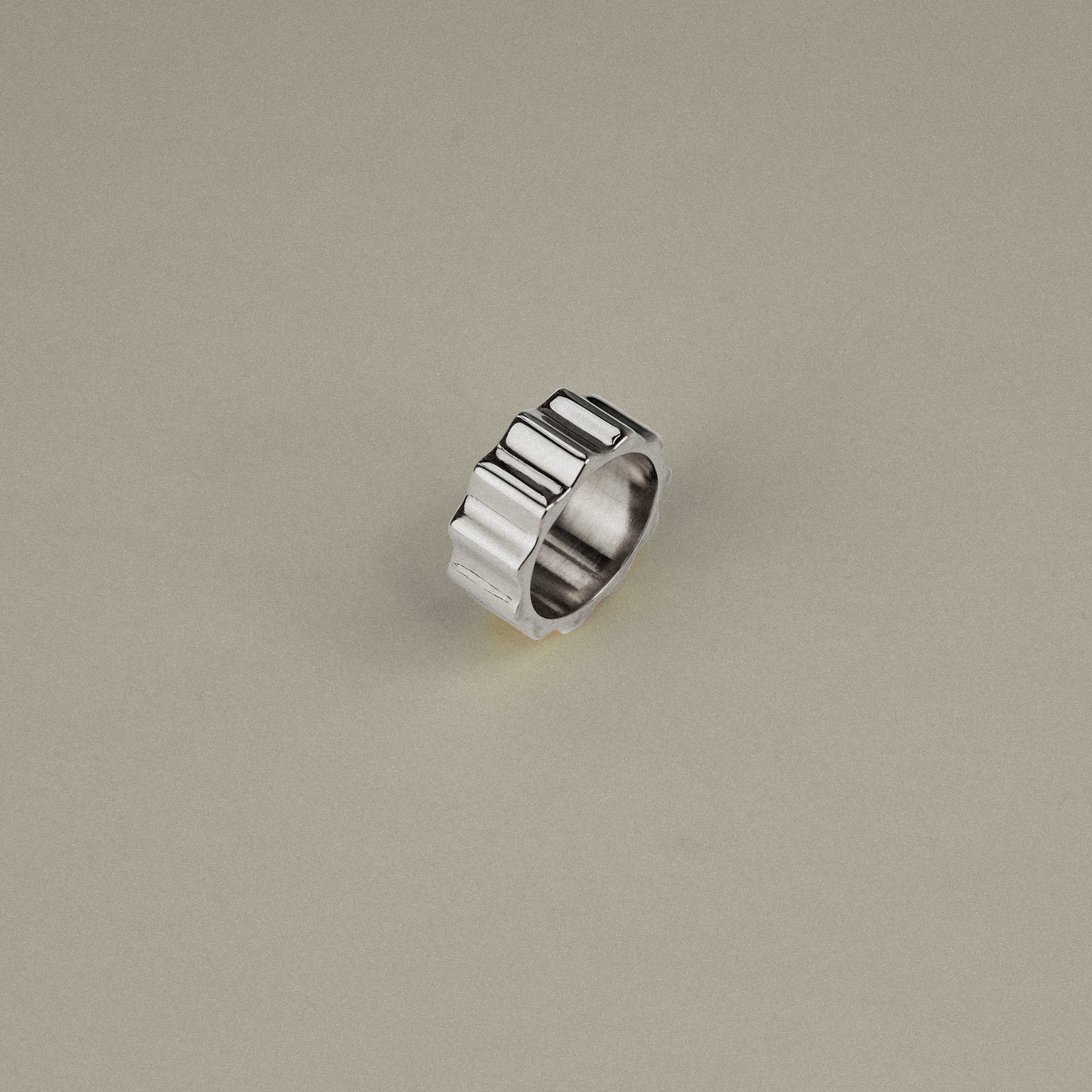 Silver ring on a beige background