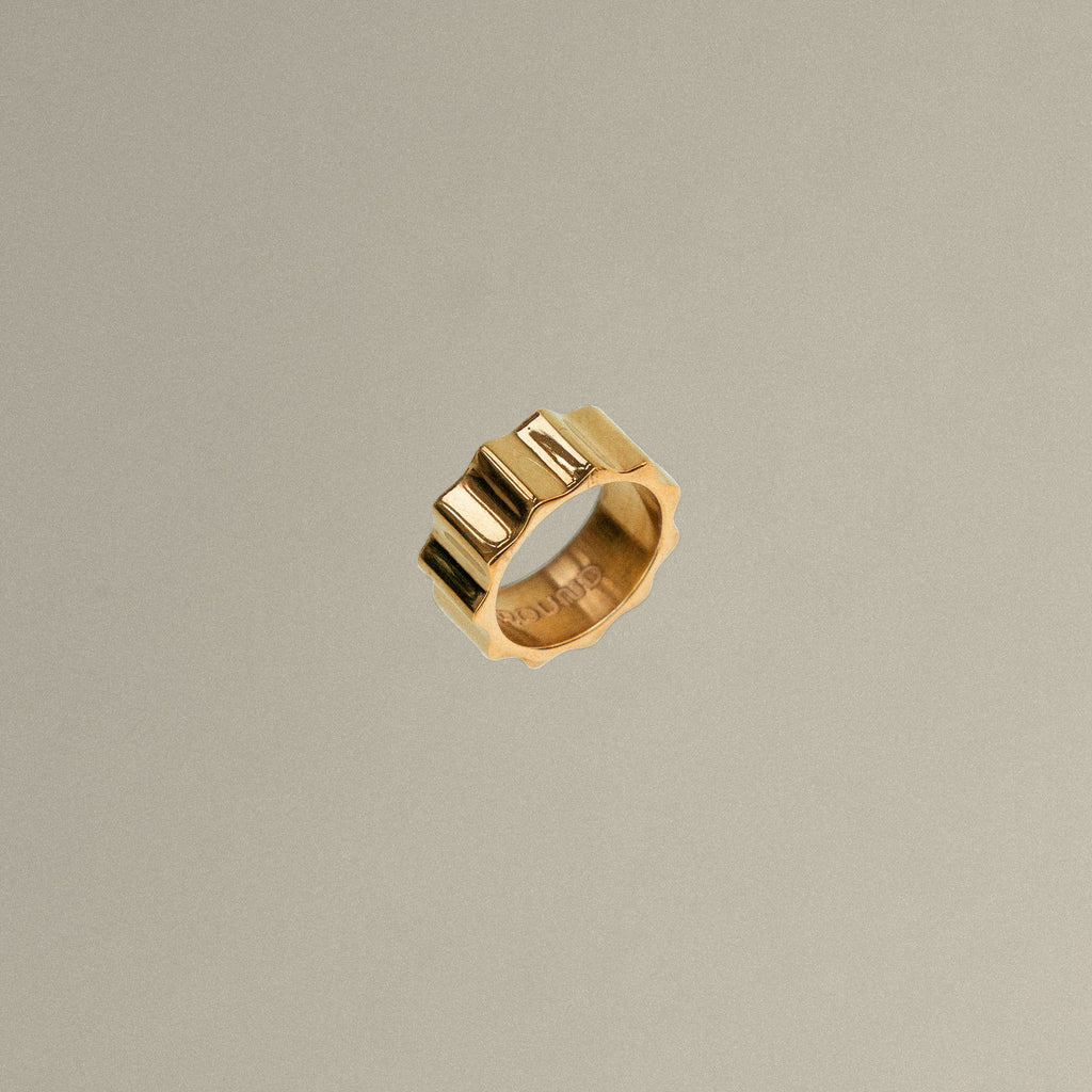 Gold ring on a beige background