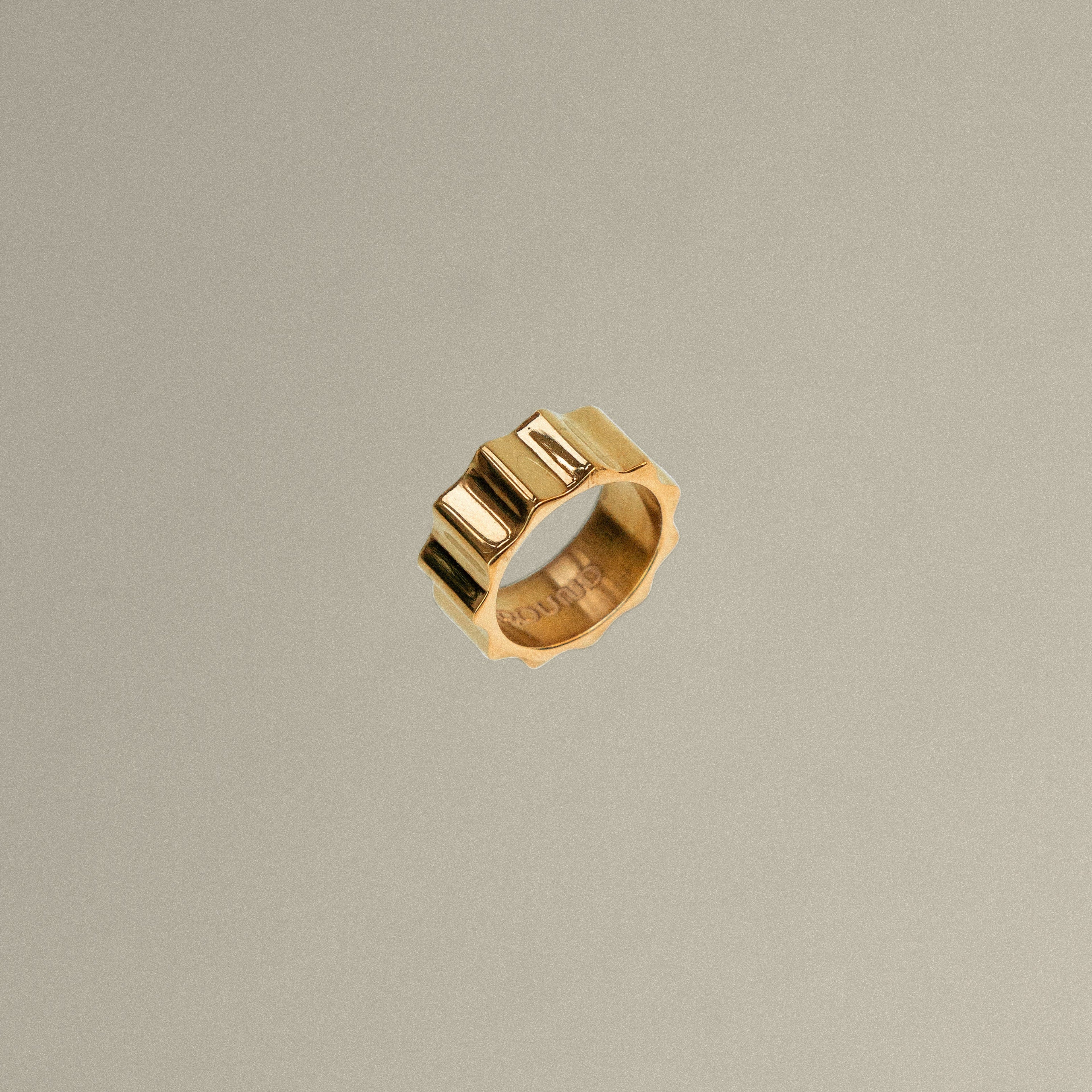 Gold ring on a beige background